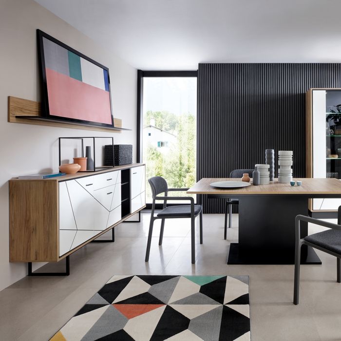 Modern living room with a television, sideboard, and dining table.