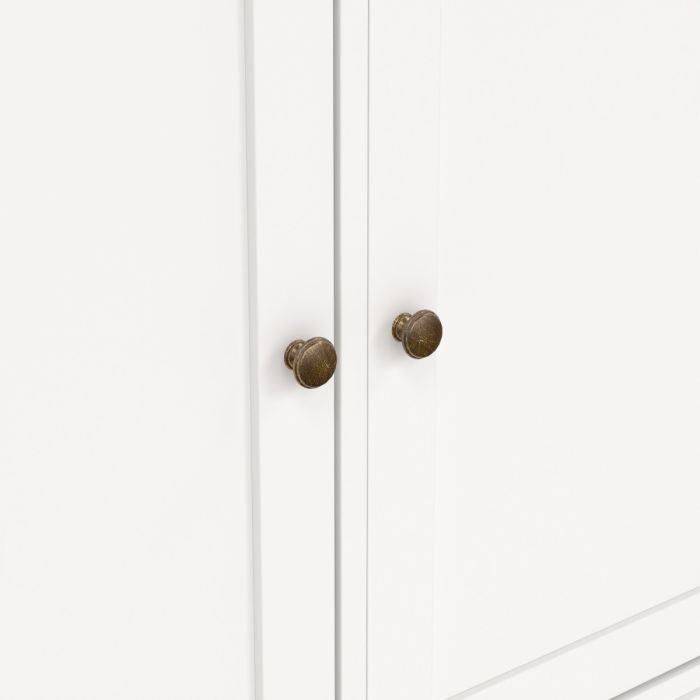 White cabinet with bronze knobs on a white background