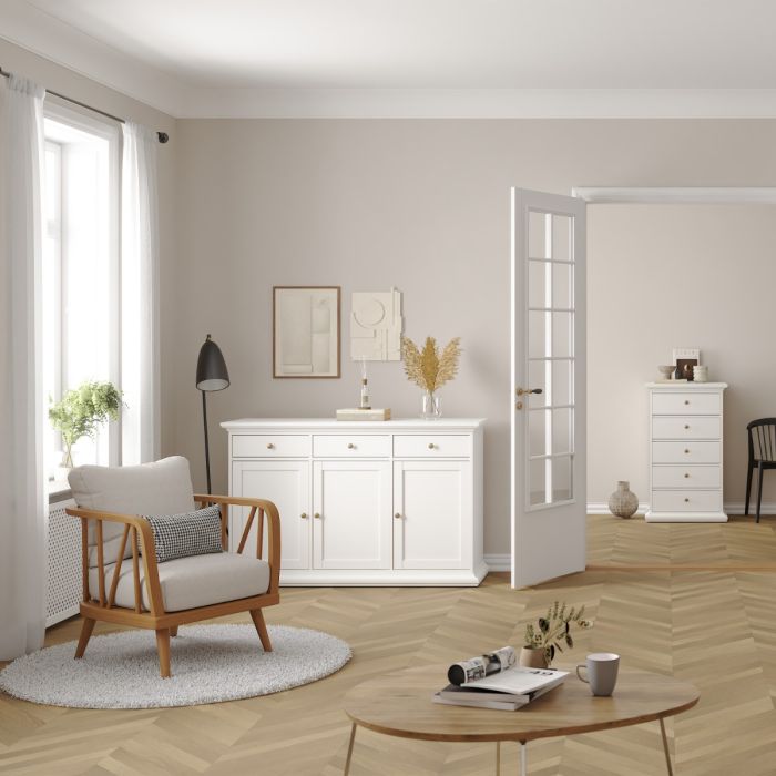 Modern living room with wooden armchair, coffee table, and white sideboard.