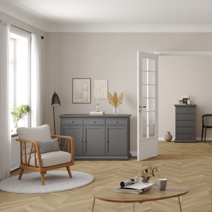 Modern living room with gray cabinet, wooden chair, and round coffee table.