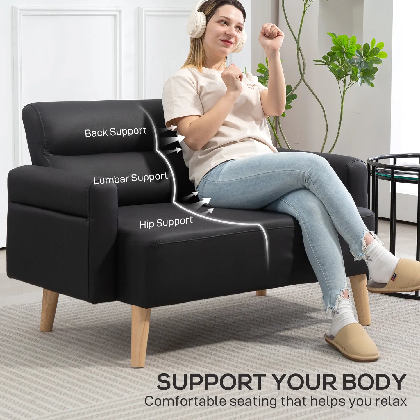 Woman sitting on a black sofa with labeled support points, in a home setting.