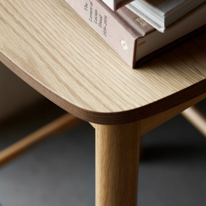 Wooden table with a book on top, blurred background