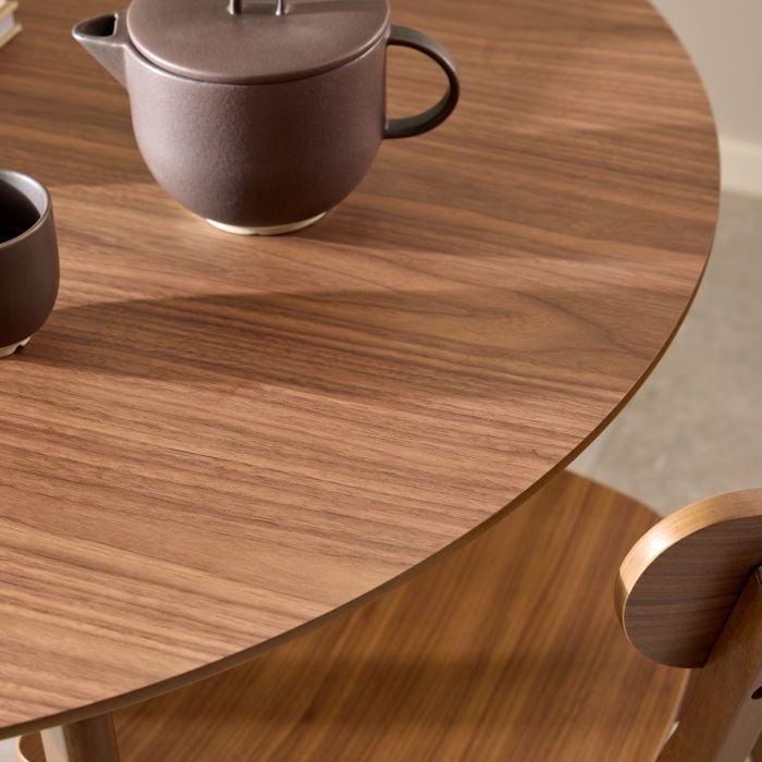 Tea set on a wooden table with a chair partially visible