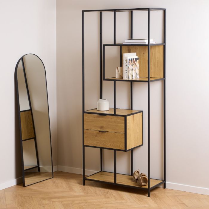Tall black metal and wooden shelf with a mirror on a wooden floor.