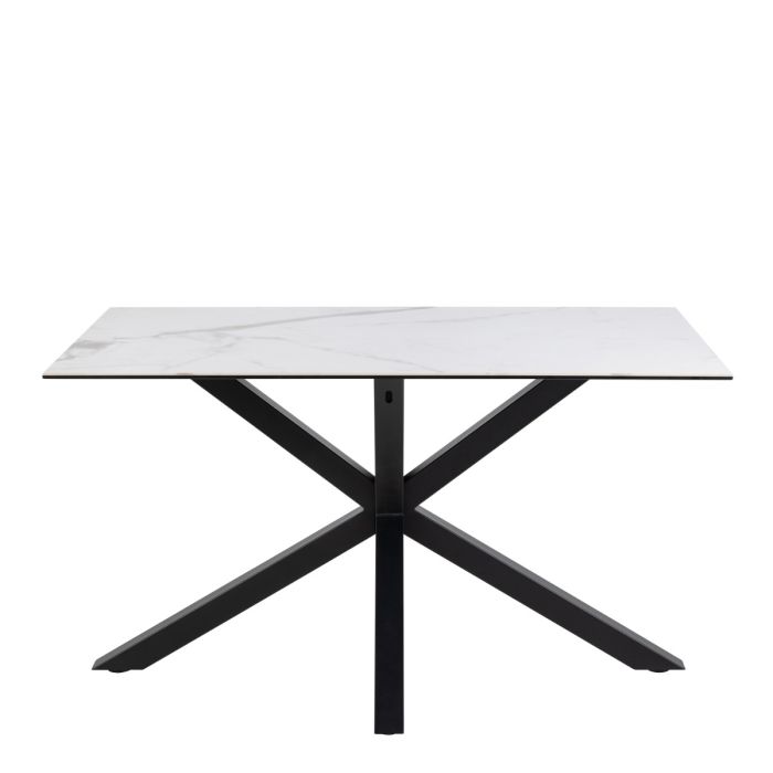 Dining table with white marble top and black metal legs on a white background