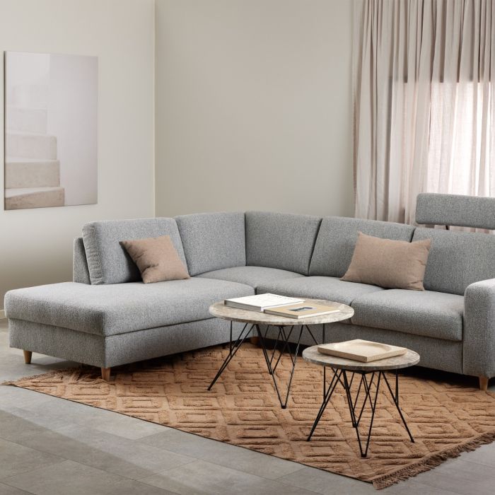 Gray sectional sofa in a living room with a coffee table and decorative items.
