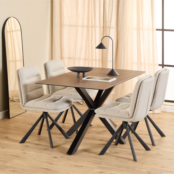 Dining table set with four chairs in a room with curtains and a lamp.