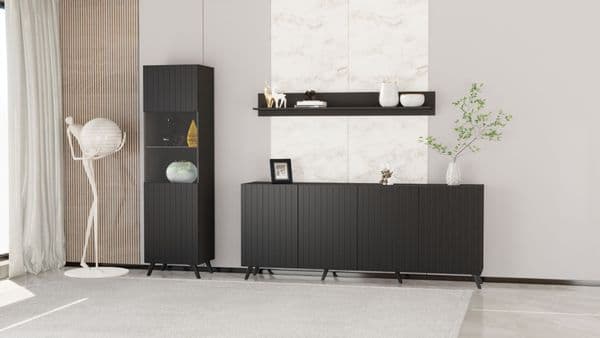 Modern interior with black furniture against a light gray wall.
