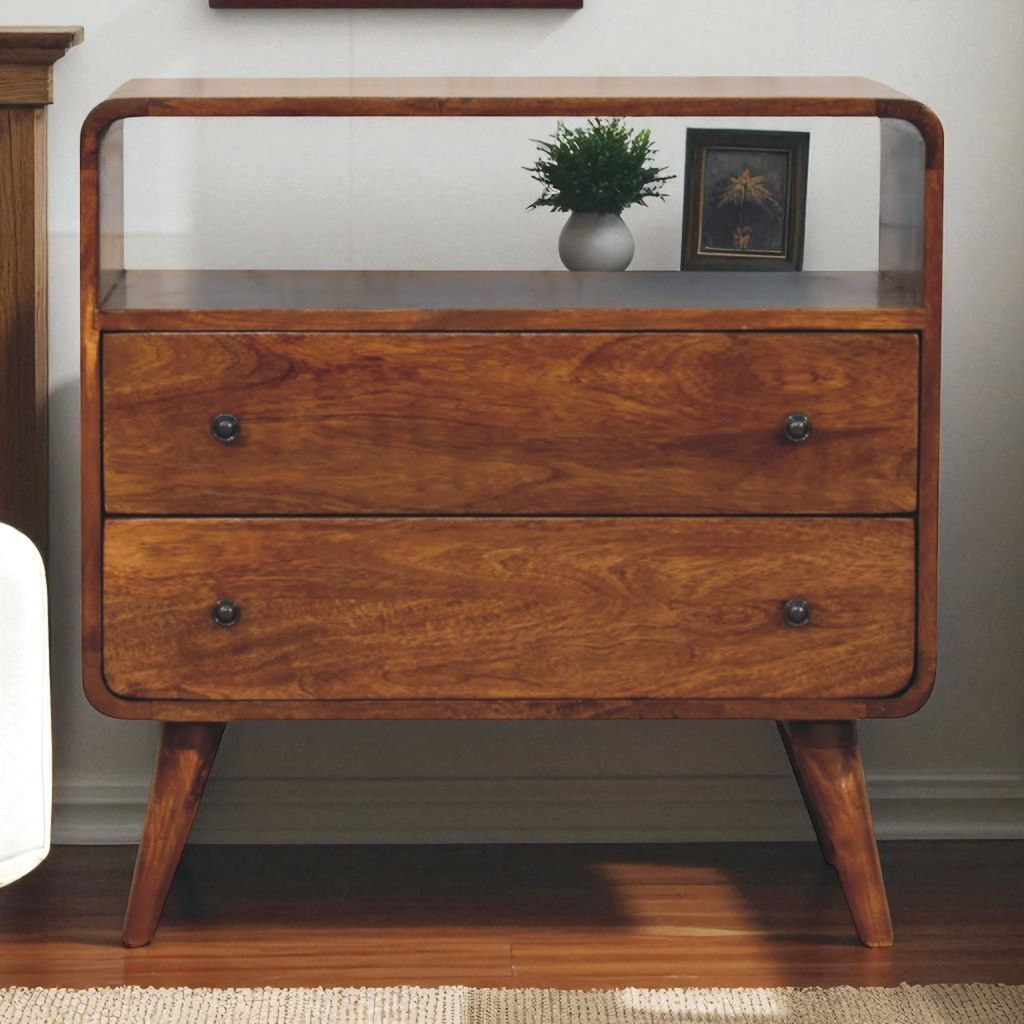 Wooden nightstand with two drawers and a small plant on top in a room setting.