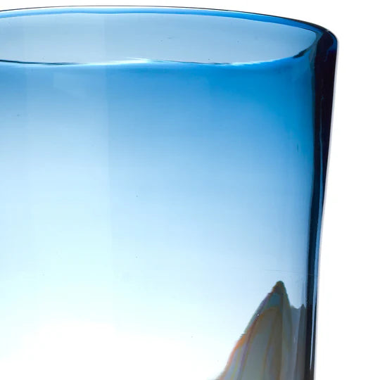 Close-up of a blue glass with a blurred background