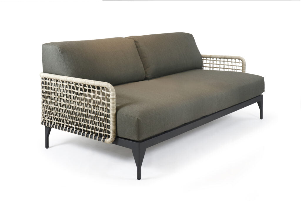 Gray sofa with wicker armrests on a white background