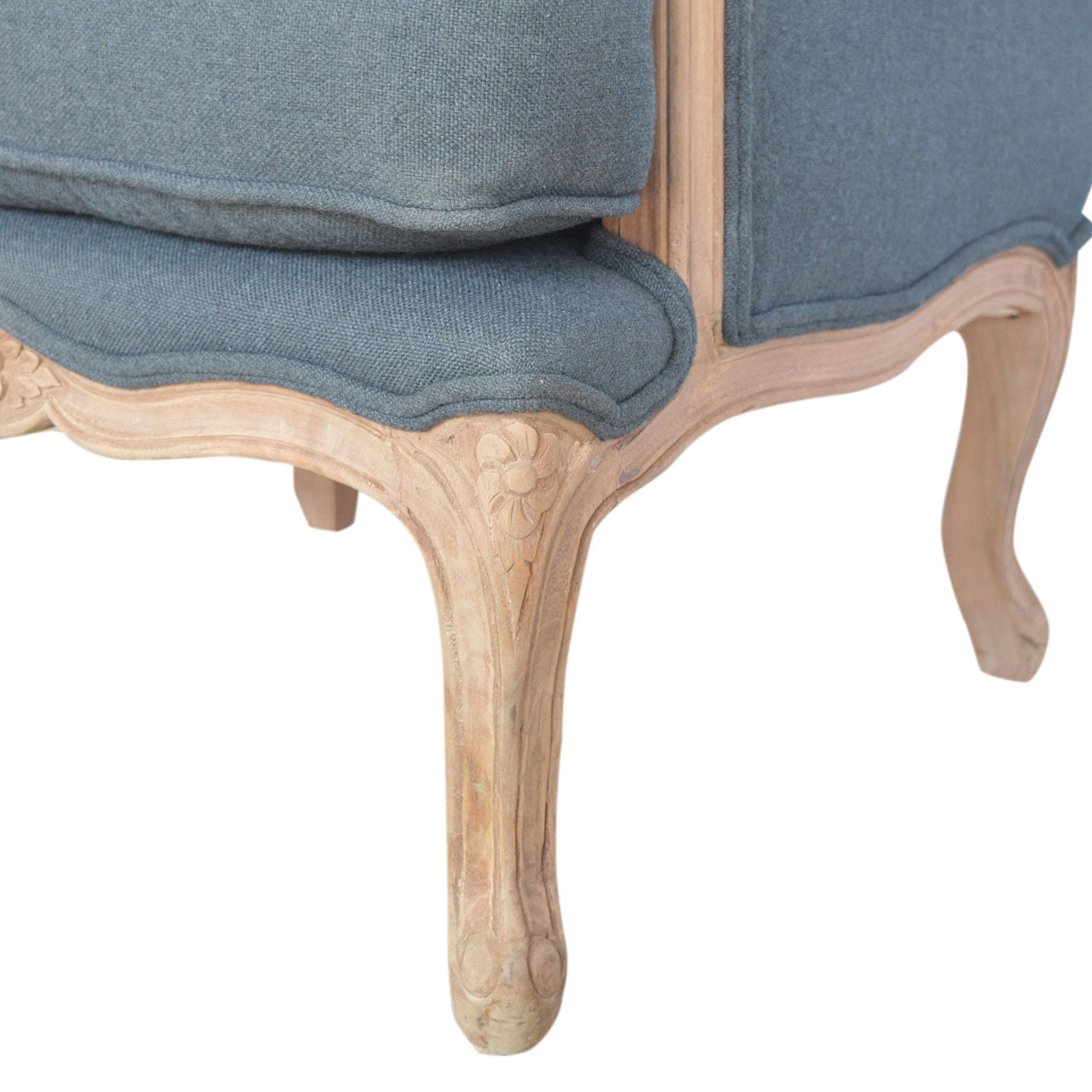 Close-up of a chair with blue fabric and wooden legs on a white background