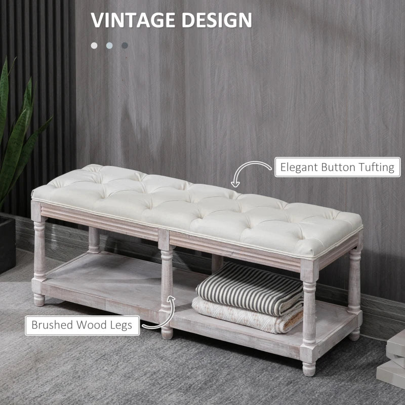White tufted bench with wooden legs against a gray wall