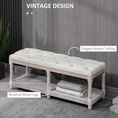 White tufted bench with wooden legs against a gray wall