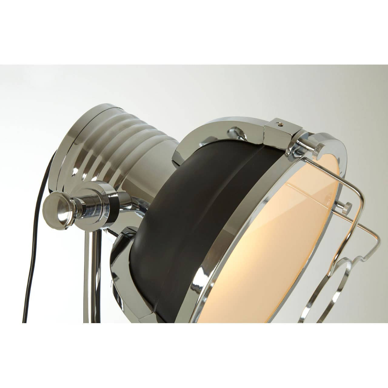 Close-up of a modern wall light fixture with metallic and glass design.