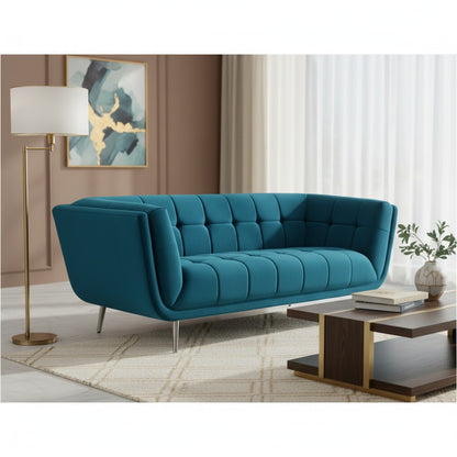 Blue sofa in a living room setting with a lamp and coffee table.