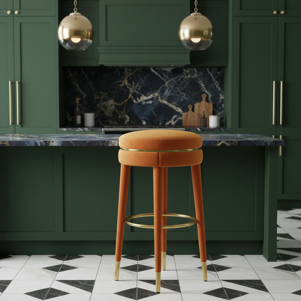 Orange bar stool in a modern kitchen with green cabinets and marble countertop.