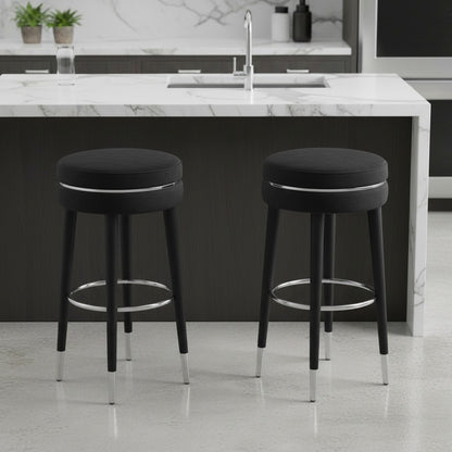Two black bar stools with chrome legs in a modern kitchen setting.