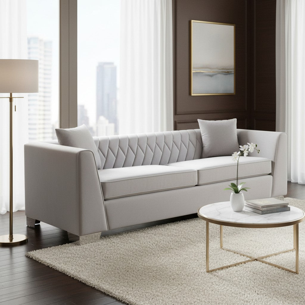 Modern living room with a gray sofa, round coffee table, and abstract painting.