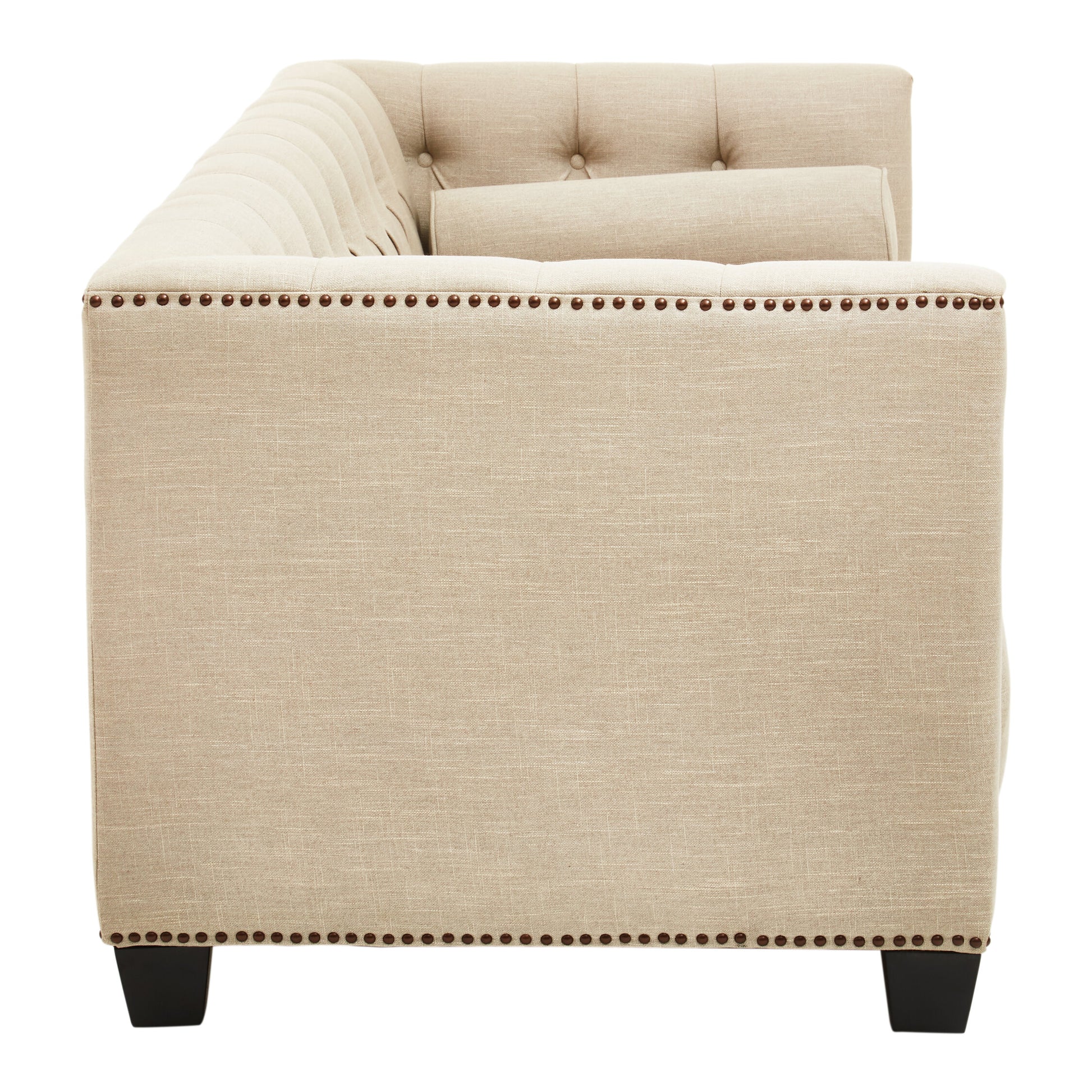 Beige upholstered chair with nailhead trim on a white background