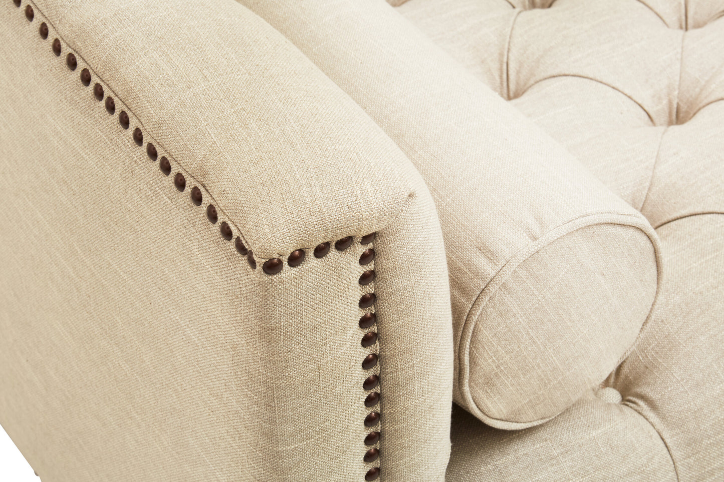 Beige upholstered chair with tufted backrest and nailhead trim