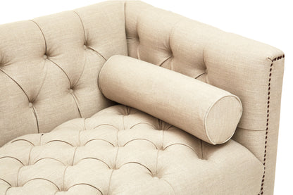 Beige tufted sofa with a cylindrical pillow on a white background