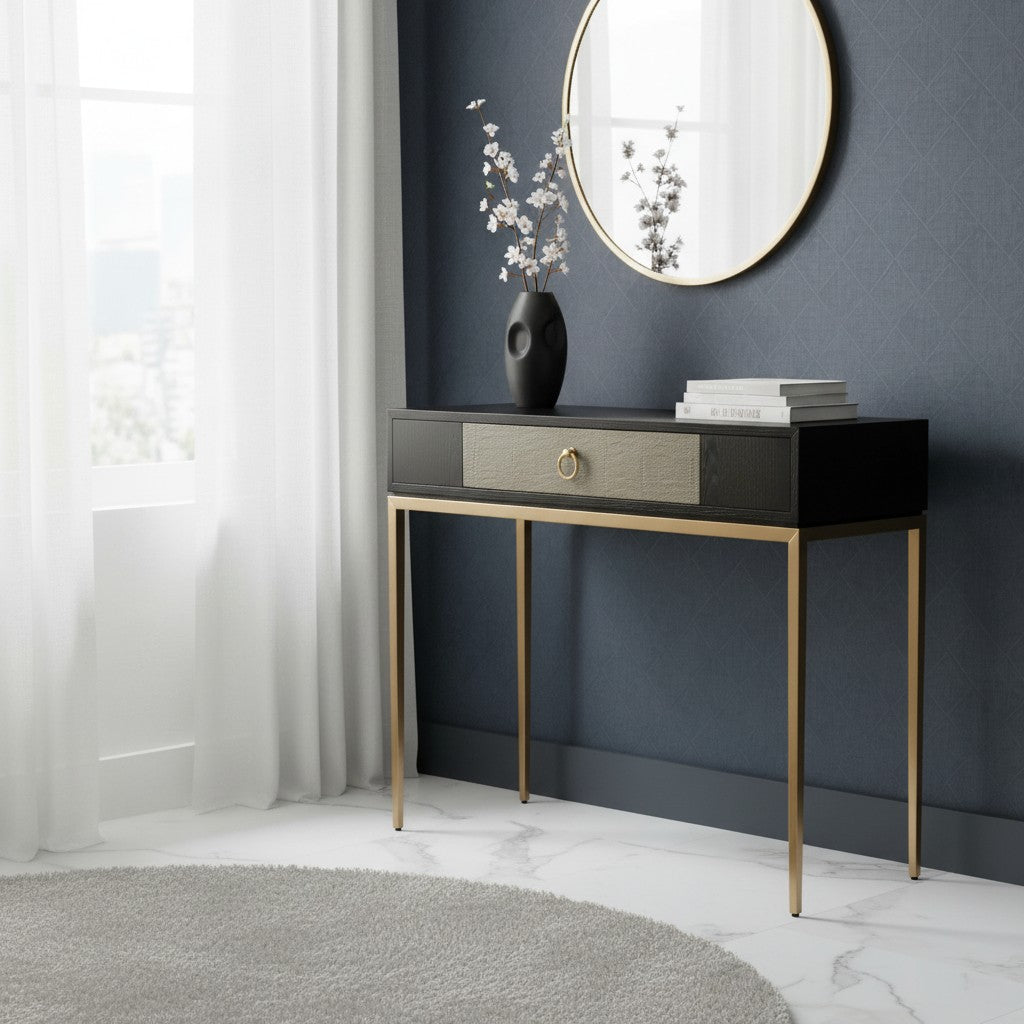 Console table with a vase and books against a dark wall with a round mirror.