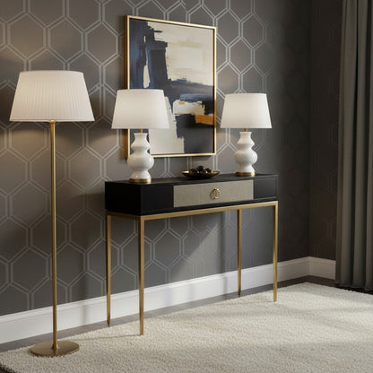 Modern console table with lamps against a geometric-patterned wall.