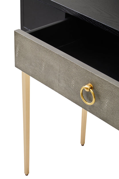 Close-up of a drawer with a gold ring handle on a white background