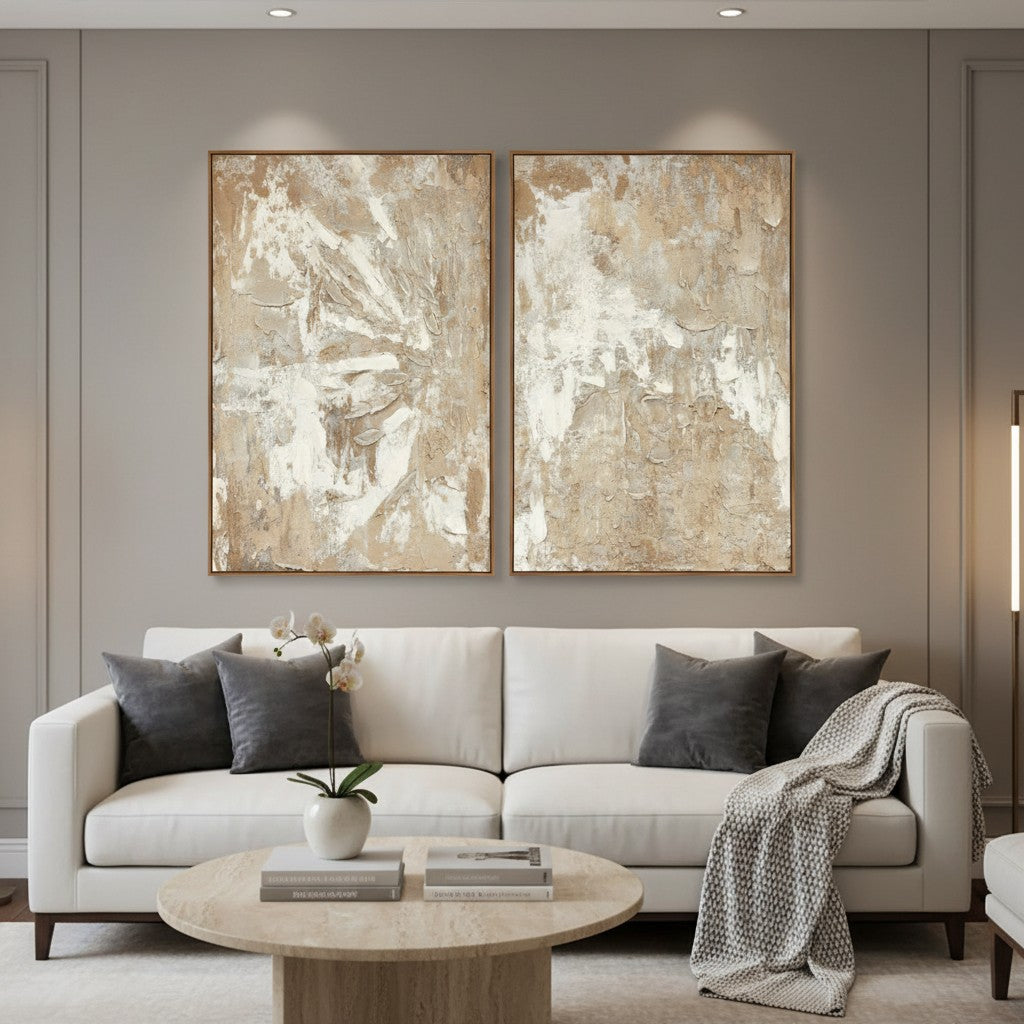 Modern living room with a white sofa, abstract art on the wall, and a round wooden coffee table.