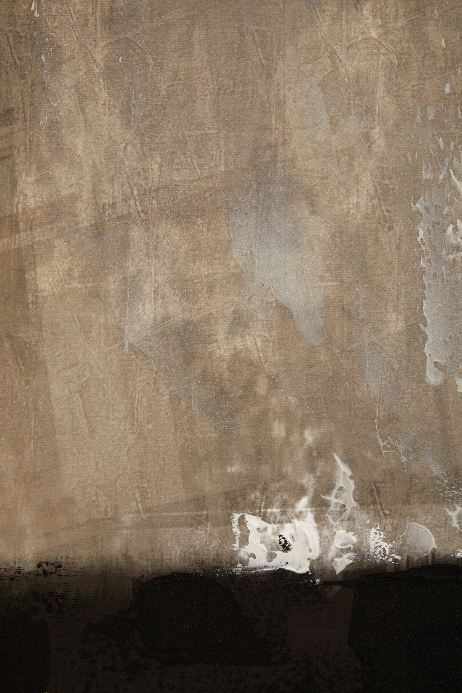 Textured brown wall with patches of white paint