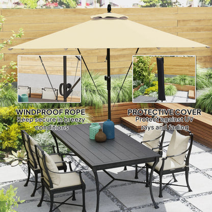 Outdoor patio set with table, chairs, and umbrella on a patio with greenery.