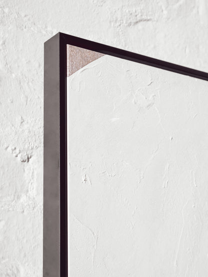 Black rectangular frame on a textured white wall