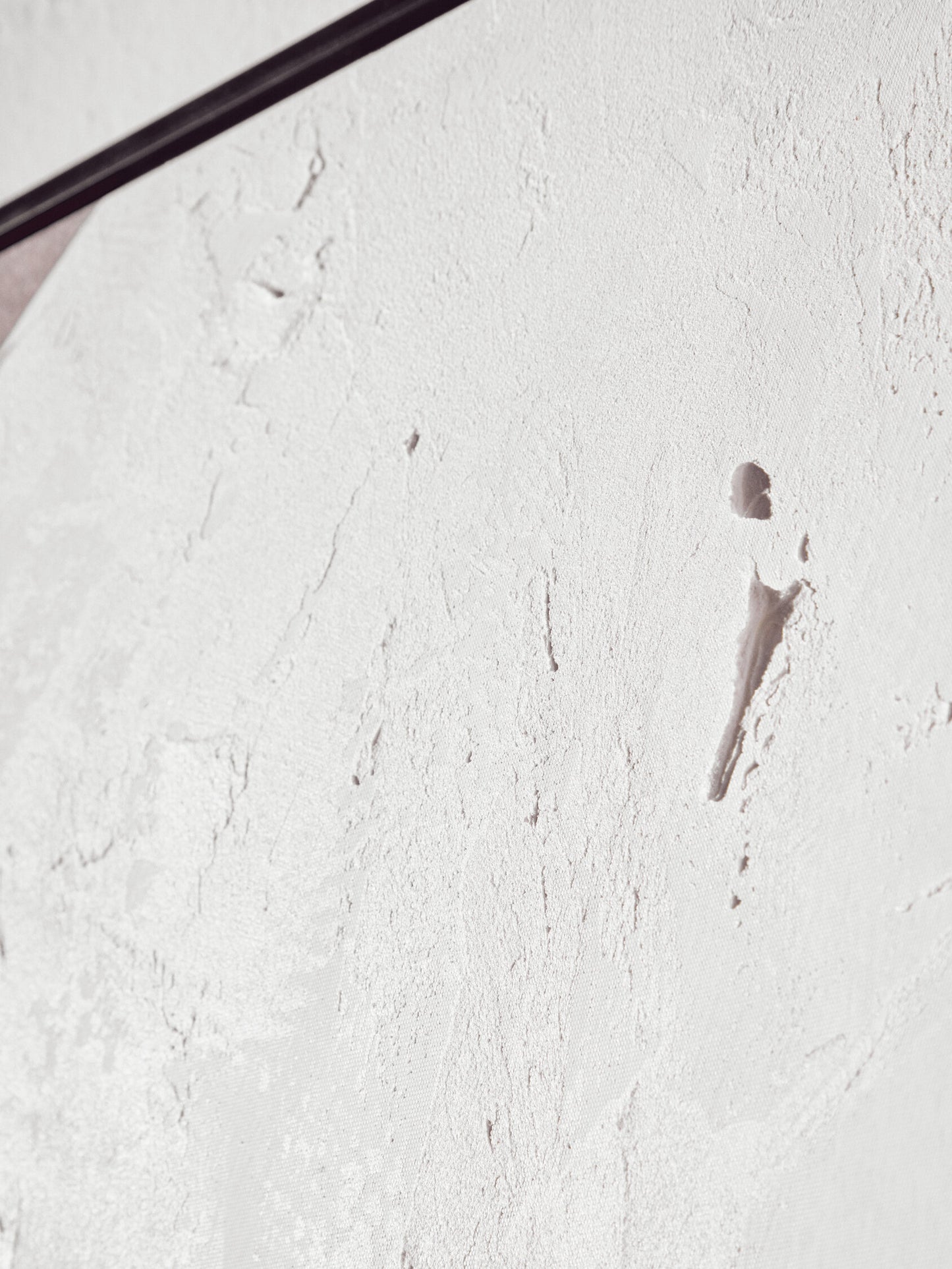Close-up of a textured white surface with a spoon on it