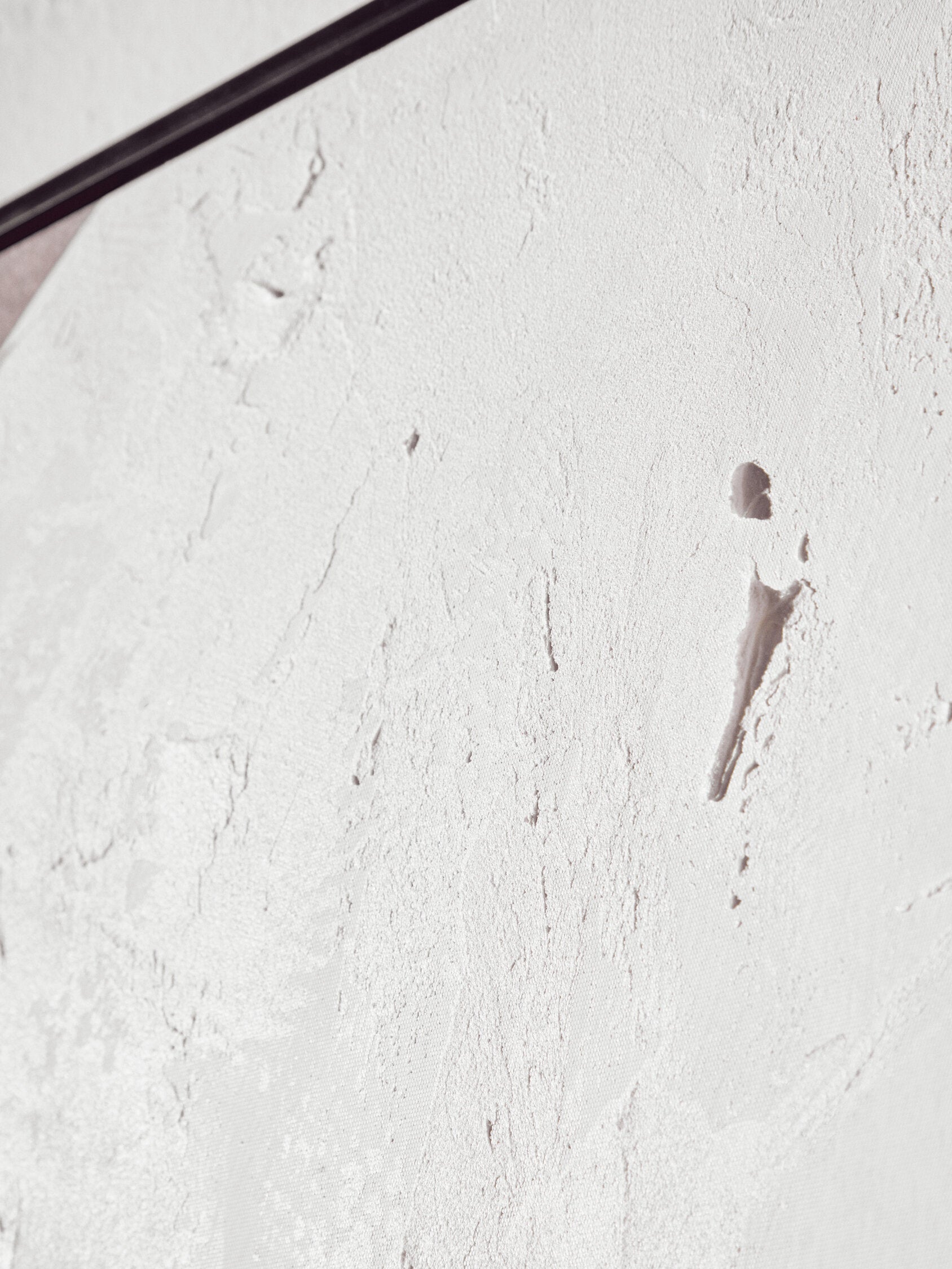 Close-up of a textured white surface with a spoon on it