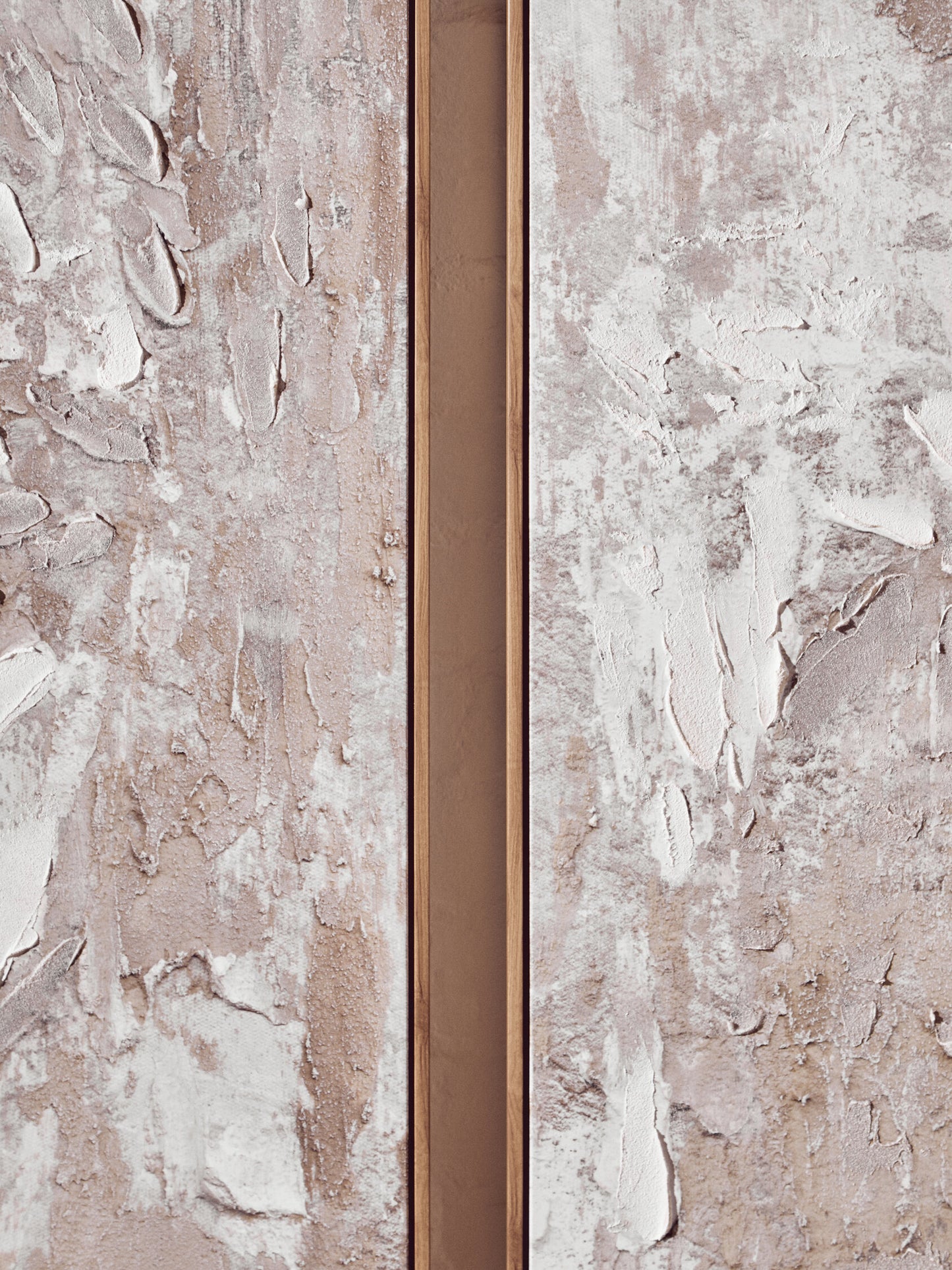 Close-up of a textured wall with a narrow metallic strip running vertically.