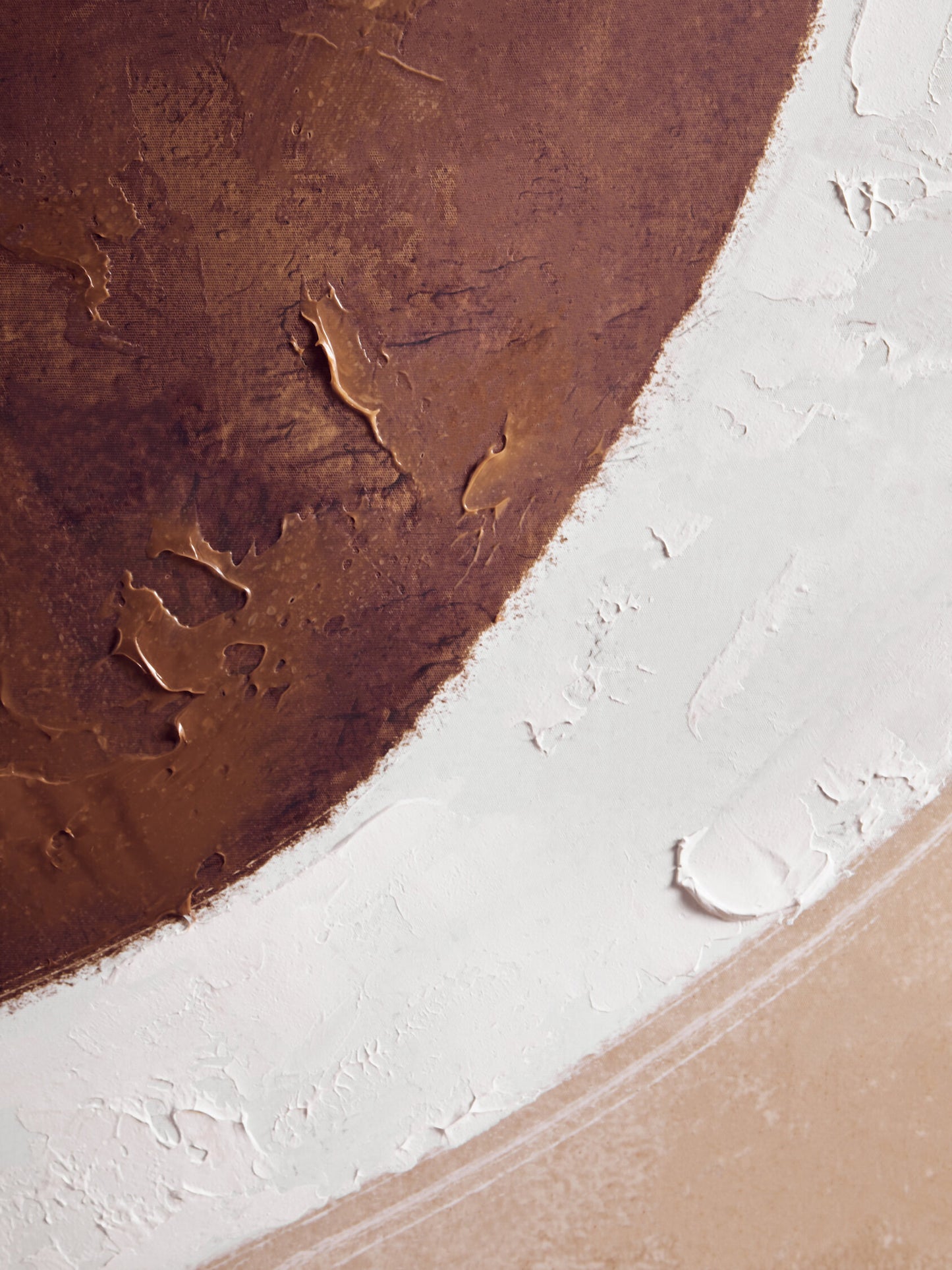 Close-up of a textured surface with brown, white, and beige colors.