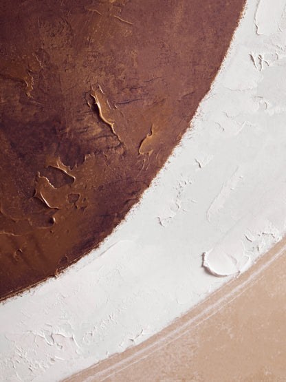 Close-up of a textured surface with brown, white, and beige colors.