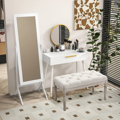 White vanity table with mirror and stool in a room with decorative elements.