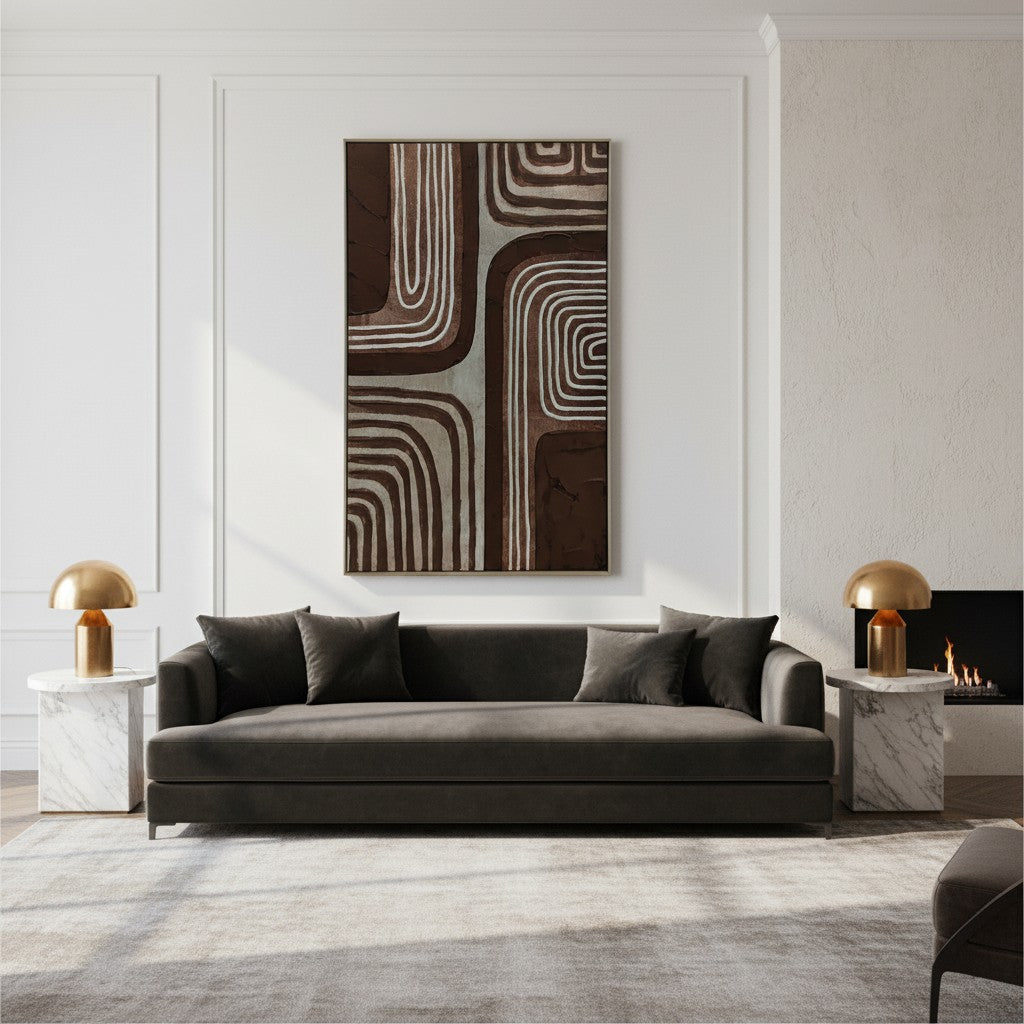 Modern living room with a gray sofa, abstract wall art, and marble side tables.
