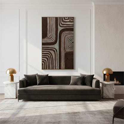 Modern living room with a gray sofa, abstract wall art, and marble side tables.