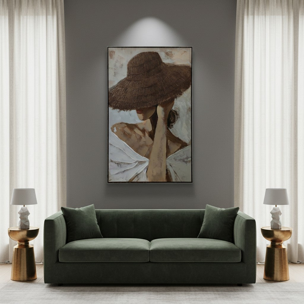 Modern living room with a green sofa, framed artwork on the wall, and side tables.