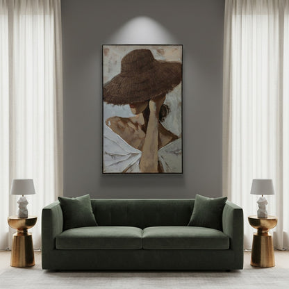 Modern living room with a green sofa, framed artwork on the wall, and side tables.