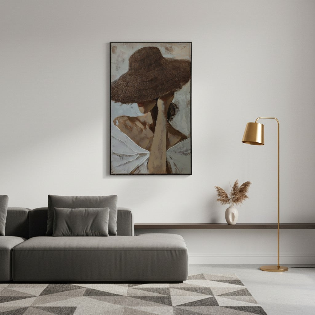 Living room with a gray sofa, gold floor lamp, and framed artwork on the wall.
