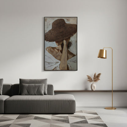 Living room with a gray sofa, gold floor lamp, and framed artwork on the wall.