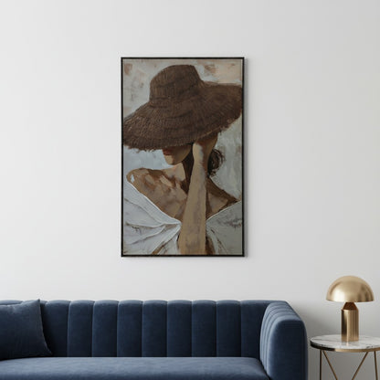 Framed artwork of a woman wearing a wide-brimmed hat above a blue sofa in a room.