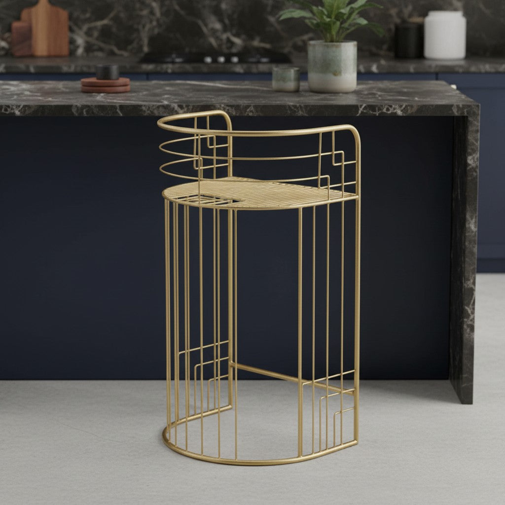 Gold metal side table with geometric design on a gray floor against a dark marble countertop.