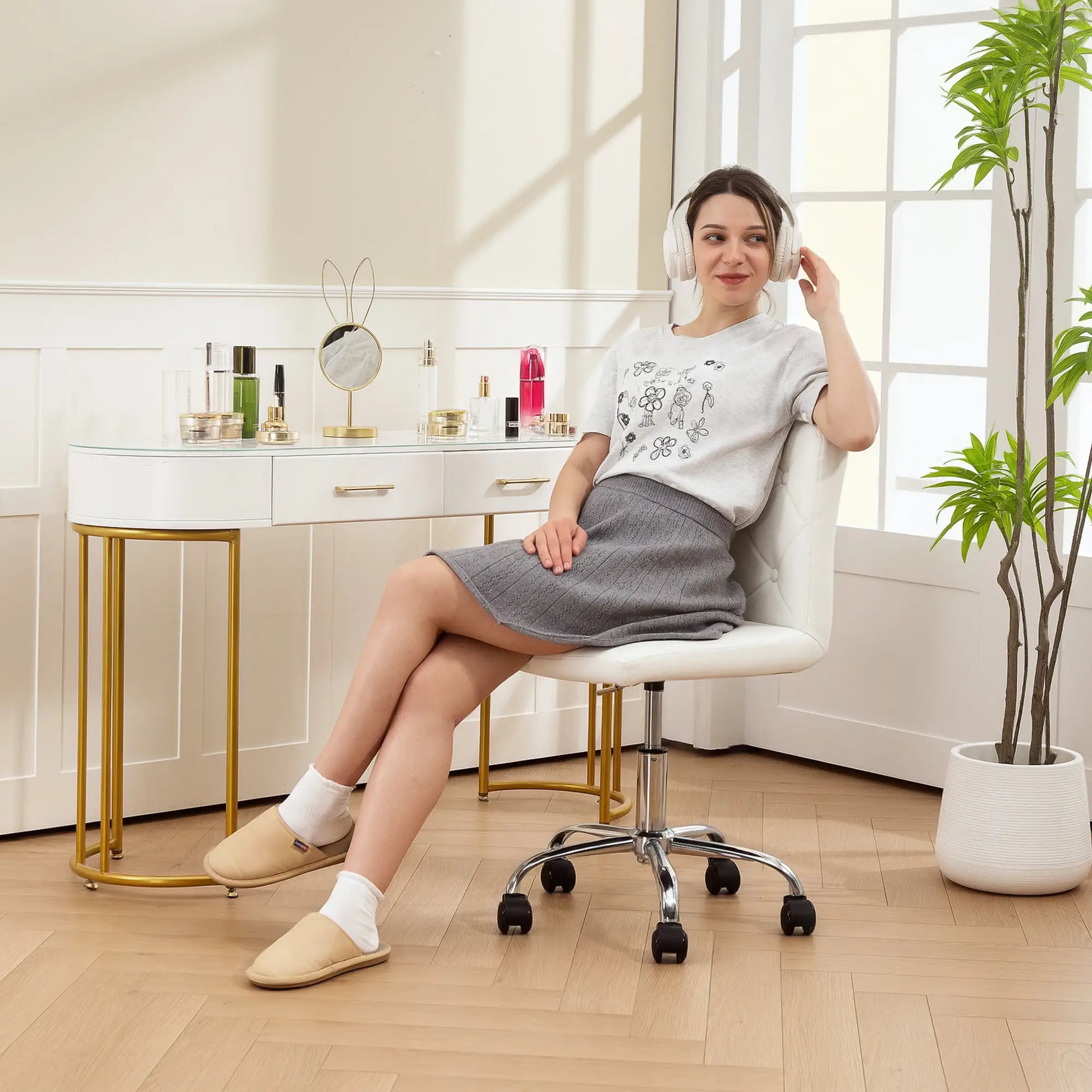Woman sitting on a chair in a room with a desk and plants