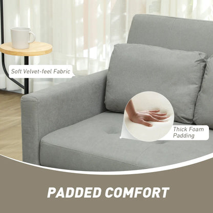 Gray sofa with text highlighting soft fabric and thick foam padding, in a living room setting.