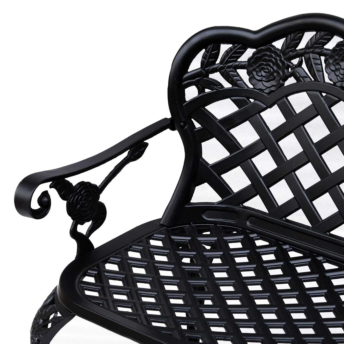 Close-up of a black metal chair with intricate designs on a white background